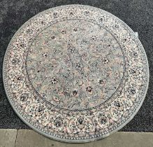 A 20th century green ground machine made circular Persian style carpet with all-over foliate design,