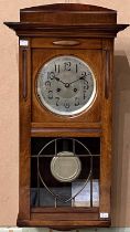 An antique mahogany wall clock with Arabic numeral dial and twin train movement, pendulum and key.