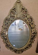 A gilt framed oval bevelled wall mirror, 76cm x 52cm, together with an oak rectangular bevelled wall