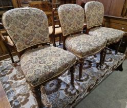 A matching set of three antique mahogany dining chairs with needlework upholstered seats, the turned