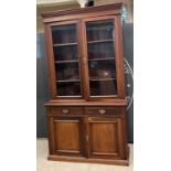 A late 19th / early 20th century mahogany display cabinet, the upper section with moulded cornice