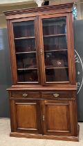 A late 19th / early 20th century mahogany display cabinet, the upper section with moulded cornice