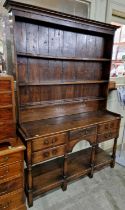 A George III reproduction oak two-part dresser, the upper section with moulded cornice above three