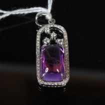 A white metal, amethyst and diamond set pendant, set with rectangular cabochon cut amethyst and four