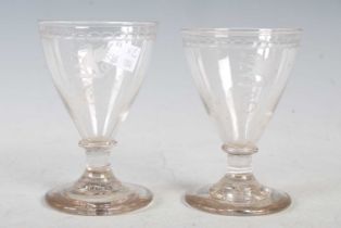 A pair of late 18th/ early 19th century conical shaped goblets with wheel cut decoration of a winged