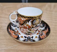 A Royal Crown Derby cup and saucer, painted marks to underside '383' and the saucer with impressed