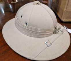 A vintage pith type helmet, the interior with label marked 'Vietnam'.