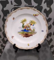 A late 19th century Meissen hand-painted cabinet plate, centred with peacocks and richly gilded