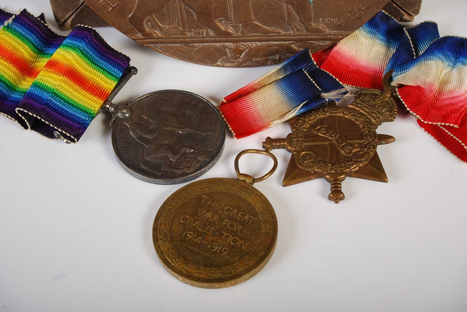 A Great War group of three medals inscribed to '54498 GNR. J. Traynor. R.A' together with a bronze - Image 2 of 2