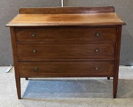 An Edwardian mahogany and inlaid chest of three long graduated drawers with brass handles, raised on