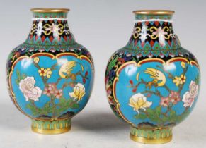A pair of Chinese blue ground cloisonne jars, early 20th century, decorated with oval shaped