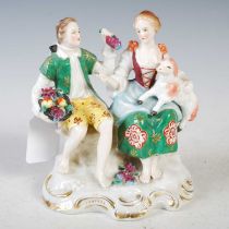 A Sitzendorf porcelain figure group modelled with female, lamb and boy holding a basket of fruit,