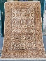 A near pair of 20th century Persian beige ground rugs, both with all-over foliate design, 190cm x