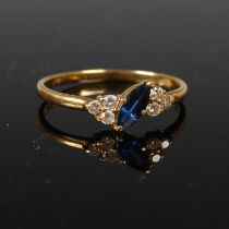 An 18ct gold sapphire and diamond cocktail ring, centred with a single marquise cut sapphire