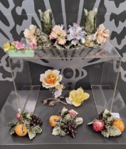 A group of four Continental ceramic floral form candle holders, a Staffordshire floral planter, a