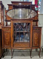 An Edwardian mahogany inlaid mirror-back display cabinet, the upper section with oval bevelled