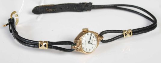 A vintage ladies 9ct gold cased Rotary wristwatch with black and white Arabic numeral dial, on black