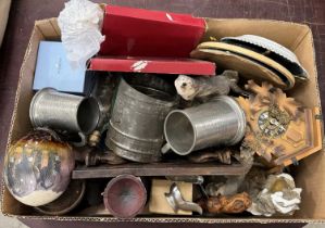 A box of mixed wares to include pewter tankards, wall clock, painted ostrich egg, Wedgwood