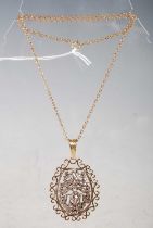 A yellow, white metal and diamond set oval shaped pendant suspended from a yellow metal chain