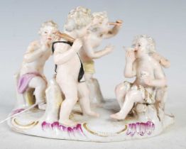 A Dresden porcelain figure group modelled with five semi-clad boys, 12.5cm high.