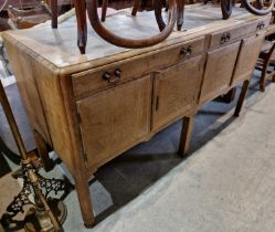 An antique oak extending dining table, the removable top with two pull-out sliding leaves, raised on