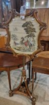 A 19th century rosewood adjustable pole-screen with embroidered scene of figures on horseback