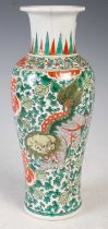 A Chinese porcelain famille verte vase, Qing Dynasty, decorated with two kylin, one with a yellow