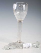 An 18th century wine glass, the ogee bowl with hammered vertical flutes on a tapered cylindrical