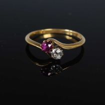 A late 19th / early 20th century diamond and ruby set two stone ring, stamped '18ct', size O,