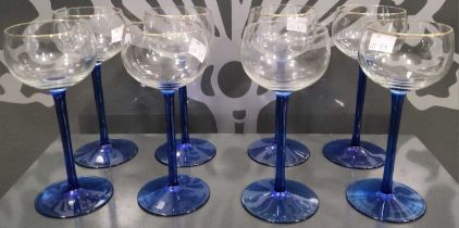 A set of eight early 20th century clear and blue glass hock glasses, the rims with gilded details.