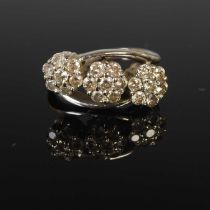 An 18ct white gold and diamond triple cluster ring, set with three clusters of seven small round