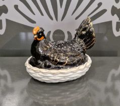 A Victorian pottery nesting hen, the base with internal painted mark '870'.