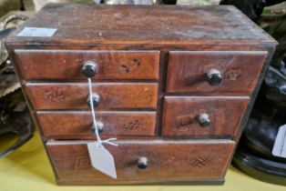 A Japanese parquetry tabletop chest of drawers, the drawer facings with parquetry inlay of different