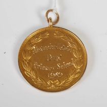 A 9ct gold Dux medal 1939, gross weight 6.1 grams.