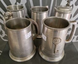 A group of five pewter tankards to include one with a glazed bottom, one with the handle in the form