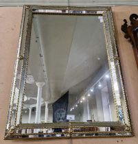 A decorative cushion framed wall mirror, 80cm x 60cm.