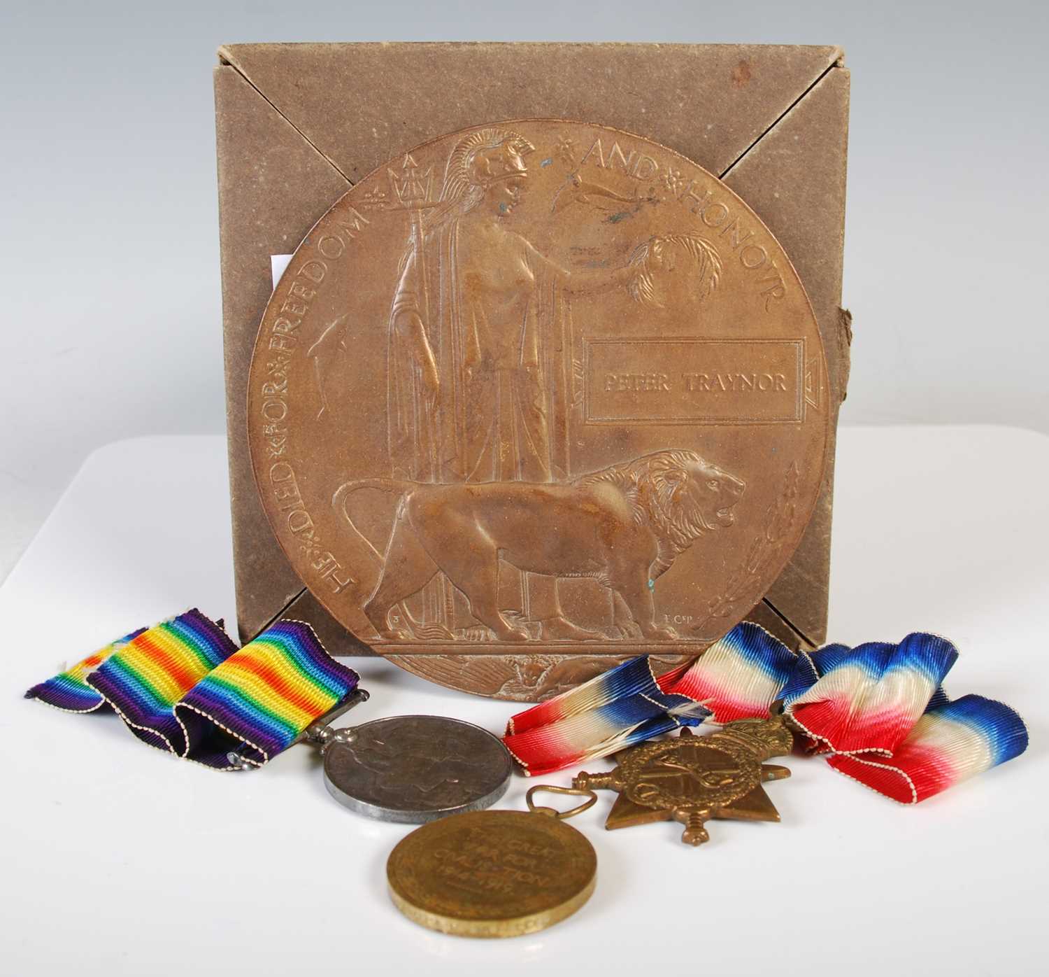 A Great War group of three medals inscribed to '54498 GNR. J. Traynor. R.A' together with a bronze