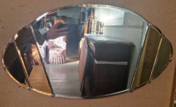 An Art Deco clear and peach glass oval bevelled wall mirror, 37cm x 66cm.