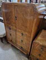 A three-piece Art Deco walnut bedroom suite, comprising side cupboard with two cupboard doors