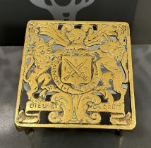 An antique brass trivet with Royal armorial crest inscribed 'Dieu Et Mon Droit'.