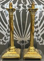A pair of brass Corinthian column table lamps.
