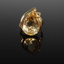 A 9ct gold and Citrine set dress ring set with a faceted pear-shaped stone, and smaller oval faceted