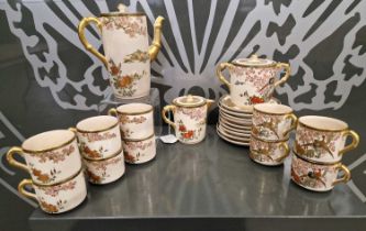 A Japanese Satsuma part tea set, decorated with exotic birds, prunus blossom and peony, with