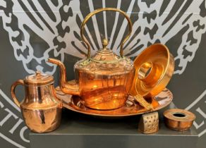 A collection of copperwares to include a large kettle, lidded jug, large circular tray etc.