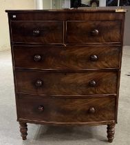 A 19th century mahogany tall bowfront chest of two short over three long drawers raised on turned