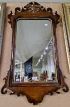 A mahogany George III style fret cut wall mirror with Hoho bird surmount, 97cm x 52cm.