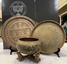 Three pieces of Eastern brassware comprising an embossed bowl on stand, the bowl decorated with