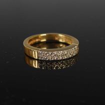 An 18ct gold and diamond ring set with two uniform rows of nine small round brilliant cut