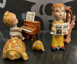 A group of five Beswick figures, comprising two turtles, child harpist, singing boy and child