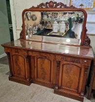 A late 19th century mahogany mirror-back sideboard, the mirror-back with carved floral surrounds,